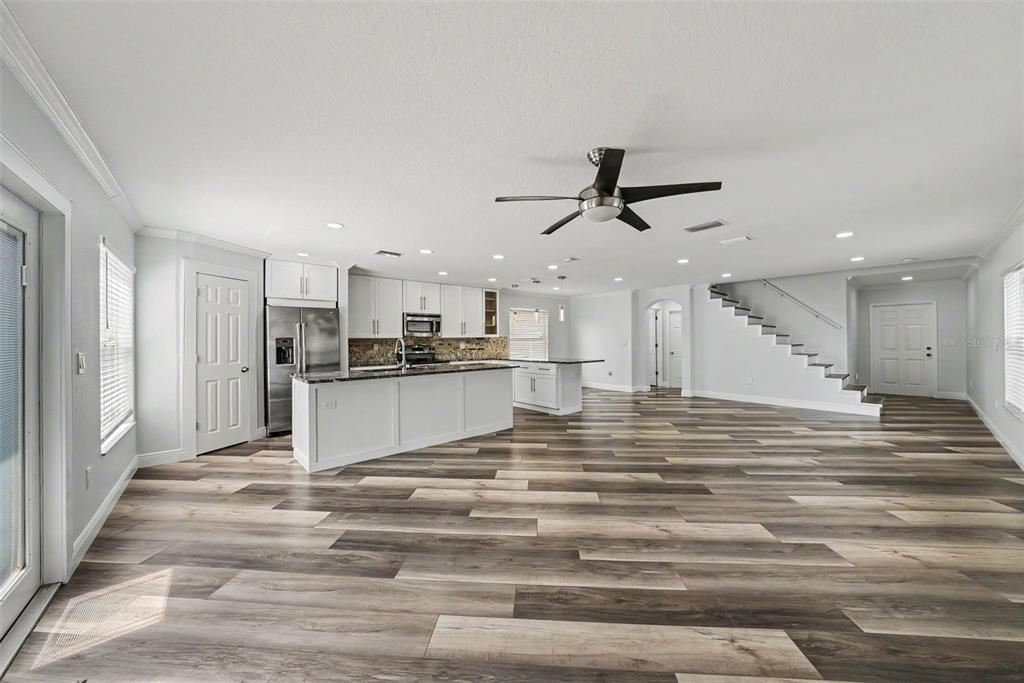 A two-story house with a light-colored stucco exterior, a two-car garage, and a driveway — 3327 THISTLEDOWN LANE, LAND O LAKES, FL