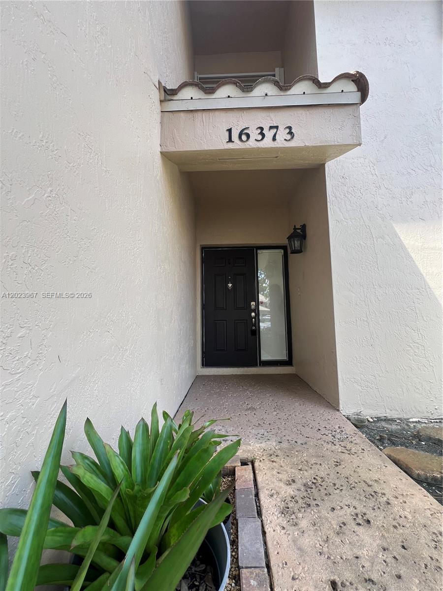 The exterior entrance features a black front door, a side window, and a house number — 16373 Malibu Dr # 51, Weston FL 33326, WESTON, FL