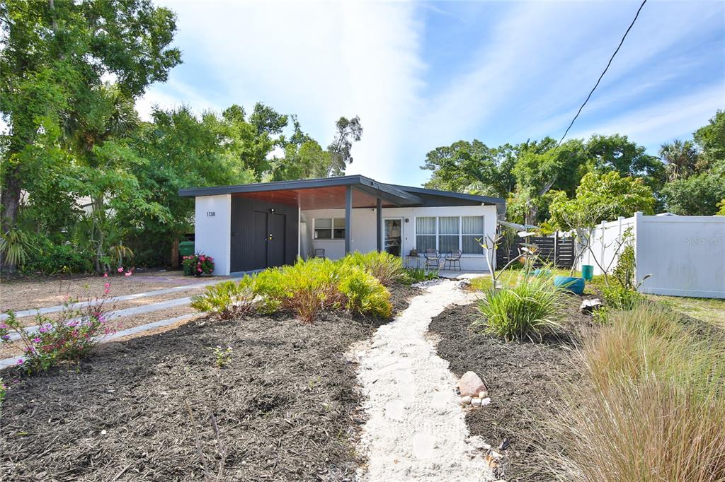 A single-story house with a flat roof, carport, and a white gravel walkway — 1138 47TH STREET, SARASOTA, FL