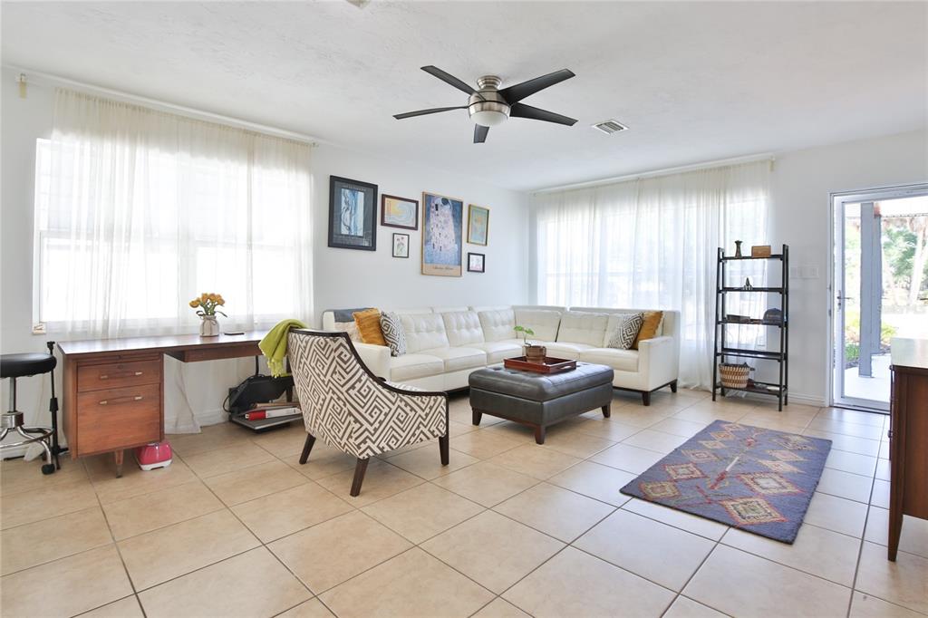 A living room features white tile floors, a sectional sofa, and a ceiling fan — 1138 47TH STREET, SARASOTA, FL