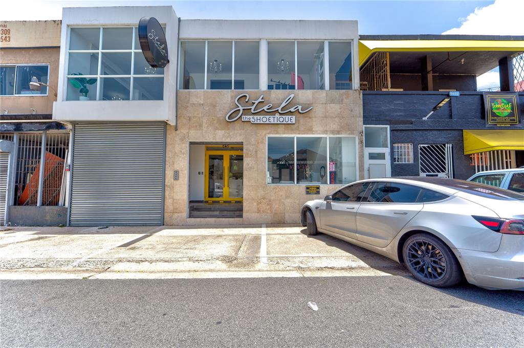 A two-story commercial building with a stone facade and a silver car parked in front — 1400 AMERICO MIRANDA AVENUE, SAN JUAN, PR