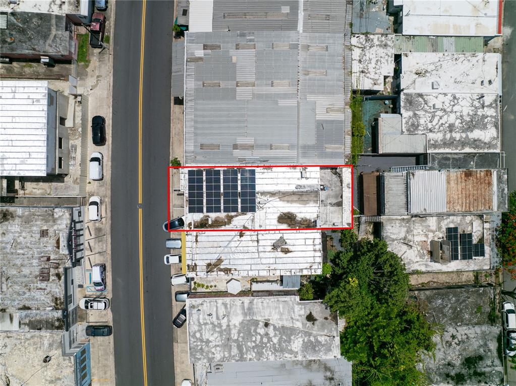 An aerial view shows a flat roof with solar panels outlined in red — 1400 AMERICO MIRANDA AVENUE, SAN JUAN, PR