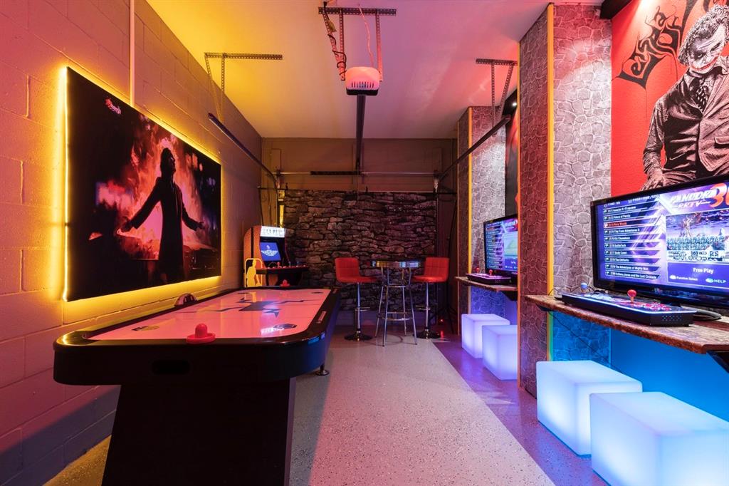 A game room features an air hockey table, arcade cabinets, and neon-lit seating — 3004 PROTAGONIST STREET, KISSIMMEE, FL