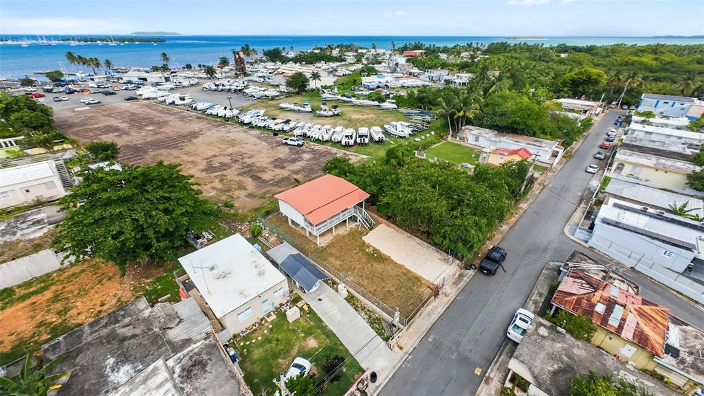 An aerial view shows a house with a red roof near a boat storage yard — . TABLAZO UNIT 507, FAJARDO, PR