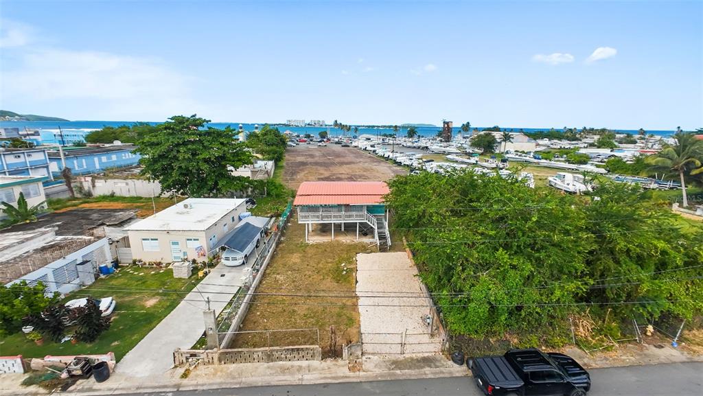 An aerial view shows a stilt house, a neighboring home, and a boat storage lot — . TABLAZO UNIT 507, FAJARDO, PR