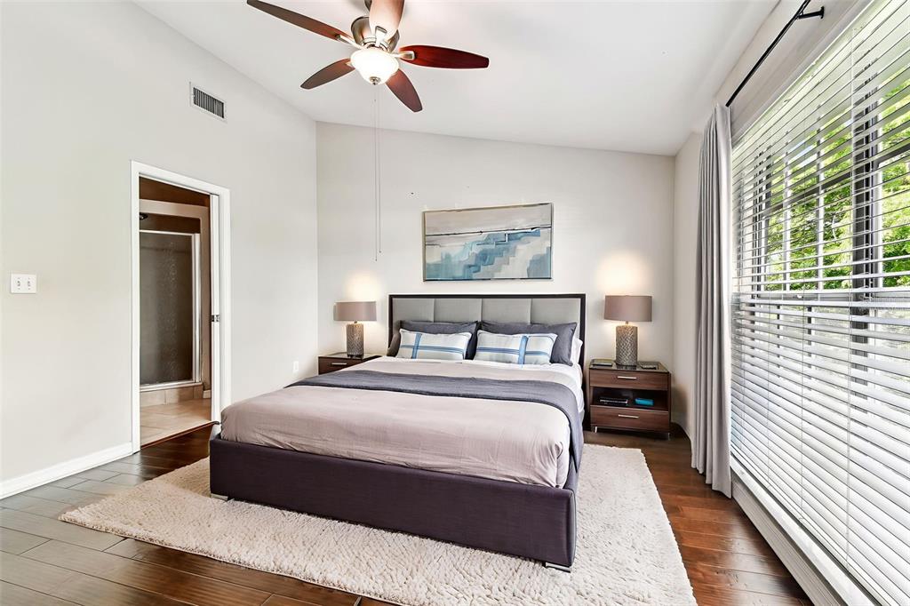 A bedroom features a queen bed, two nightstands, a ceiling fan, and hardwood flooring — 609 S GLEN AVENUE UNIT E, TAMPA, FL