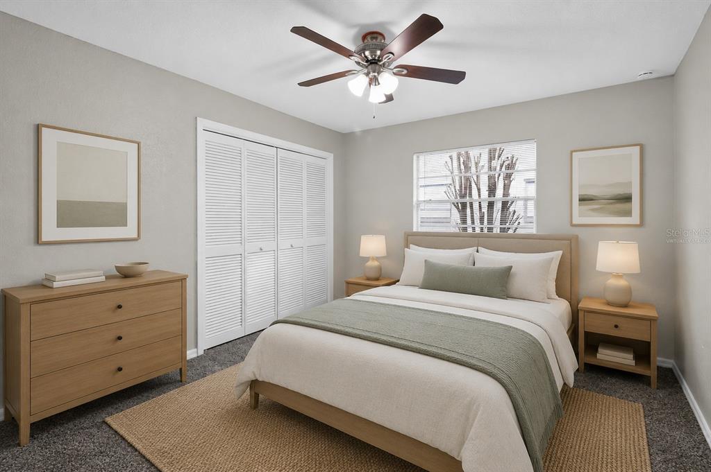 A bedroom with a queen bed, wooden dresser, nightstands, and a ceiling fan — 9504 VIA SEGOVIA, NEW PORT RICHEY, FL
