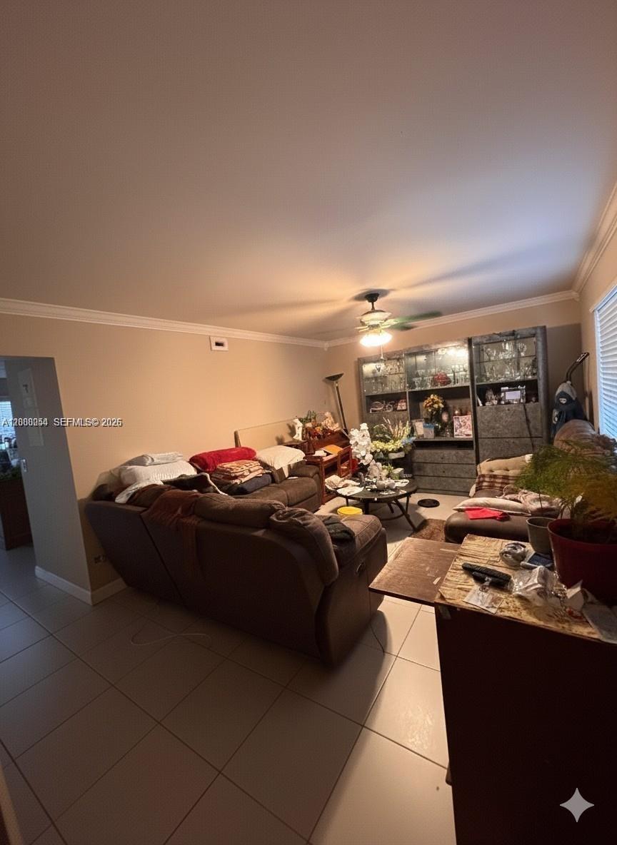 A living room features a large brown sectional sofa, a glass coffee table, and a display cabinet — 1415 NW 80th Ave # D, Margate FL 33063, MARGATE, FL