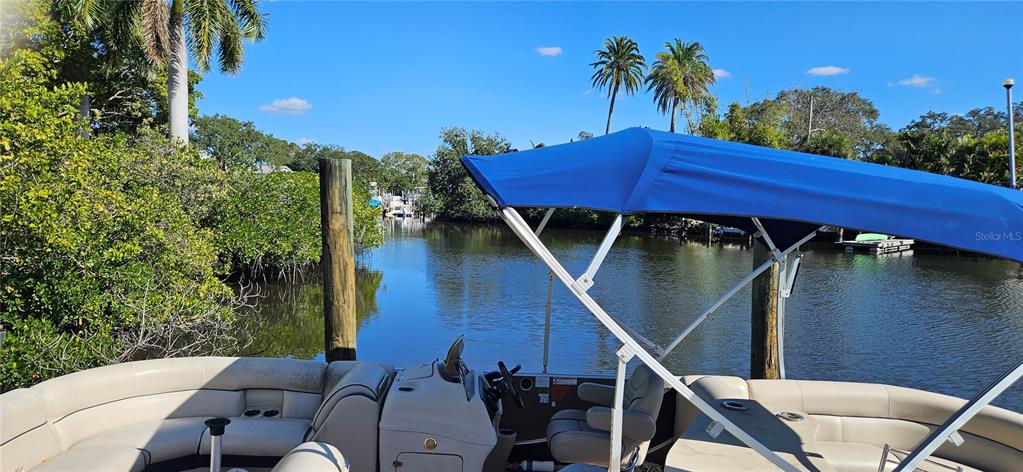 A view from the deck of a pontoon boat looking out over a calm canal — TENNESSEE AVENUE, CRYSTAL BEACH, FL