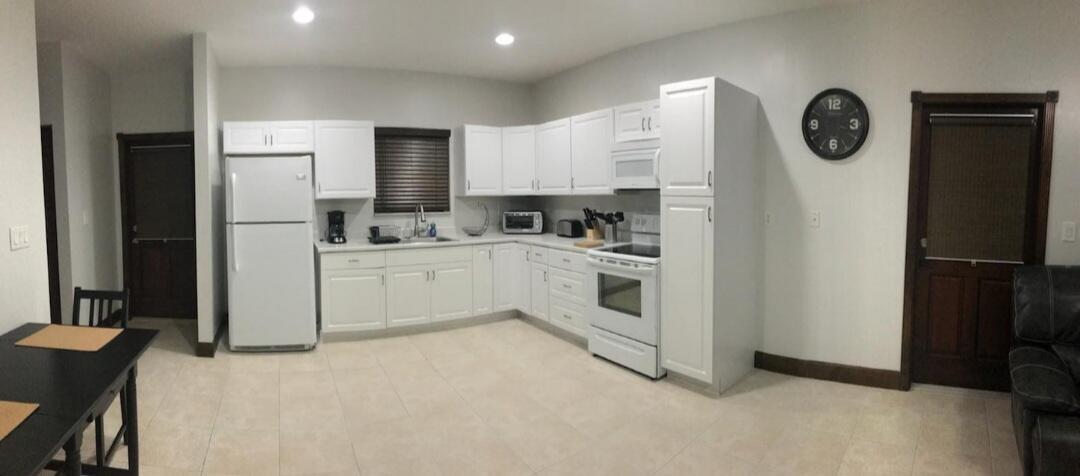 A kitchen with white cabinets, white appliances, and light tile flooring — 15831 N 44th St Street N, FL 33470, FL