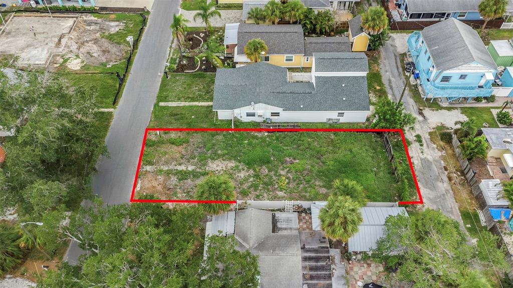 An aerial view shows a vacant rectangular residential lot outlined in red between two houses — 3020 CLINTON STREET S, GULFPORT, FL