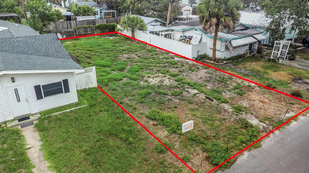 An aerial view shows a vacant rectangular lot outlined in red next to a house — 3020 CLINTON STREET S, GULFPORT, FL
