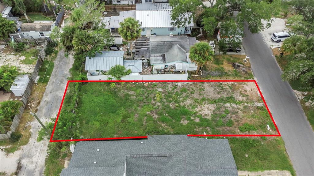 An aerial view shows a rectangular vacant lot outlined in red between two residential streets — 3020 CLINTON STREET S, GULFPORT, FL