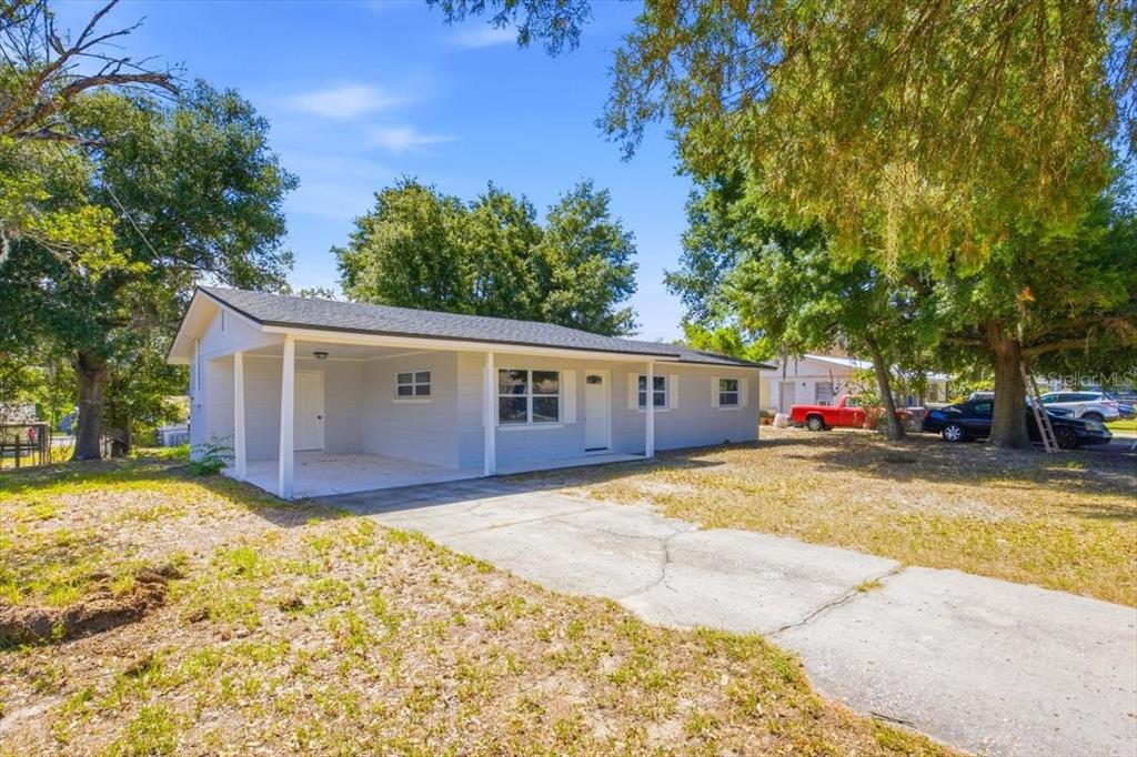 A white front door and window with shutters are on the exterior of a house — 827 EVERETT STREET, LAKE ALFRED, FL