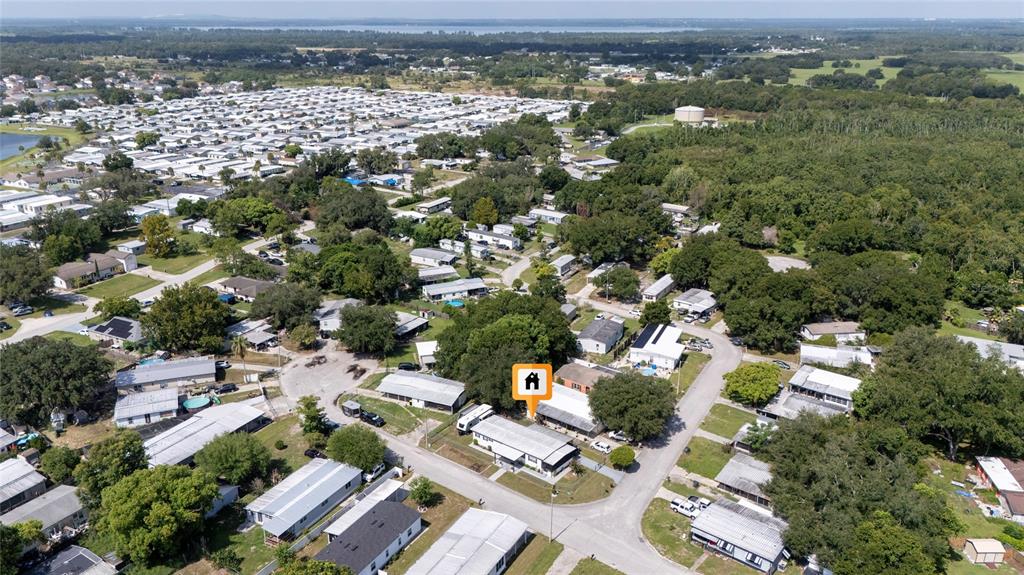 An aerial view shows a residential neighborhood with a highlighted single-story house — 24 FLAMINGO BOULEVARD, WINTER HAVEN, FL
