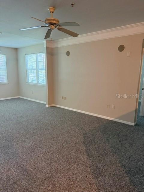A carpeted living room features a ceiling fan and a window with blinds — 3250 CORONA VILLAGE WAY UNIT 108, ORLANDO, FL