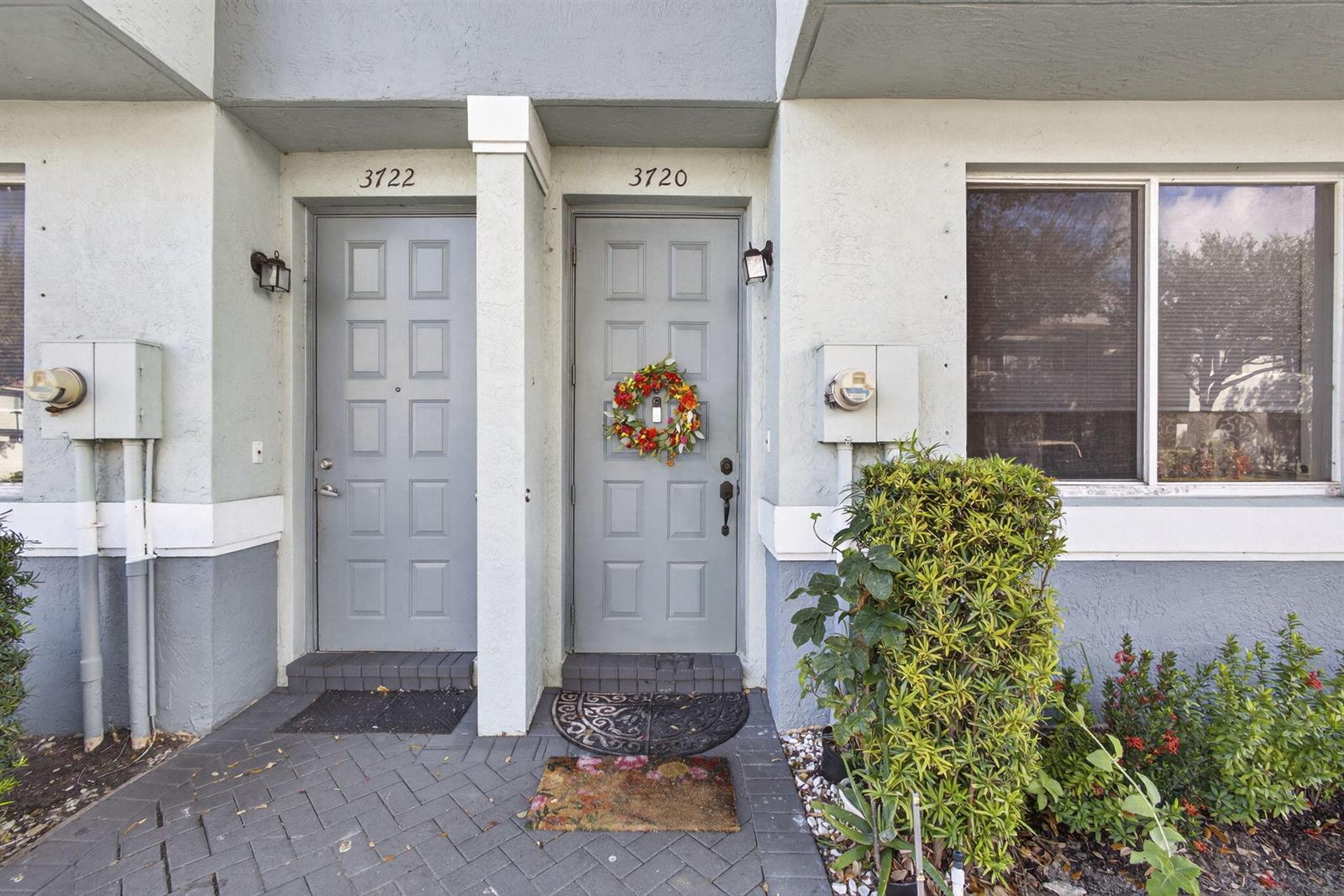 The exterior view shows two adjacent gray front doors with house numbers and a bush — 3720 Oleander Terrace, Riviera Beach FL 33404, RIVIERA BEACH, FL