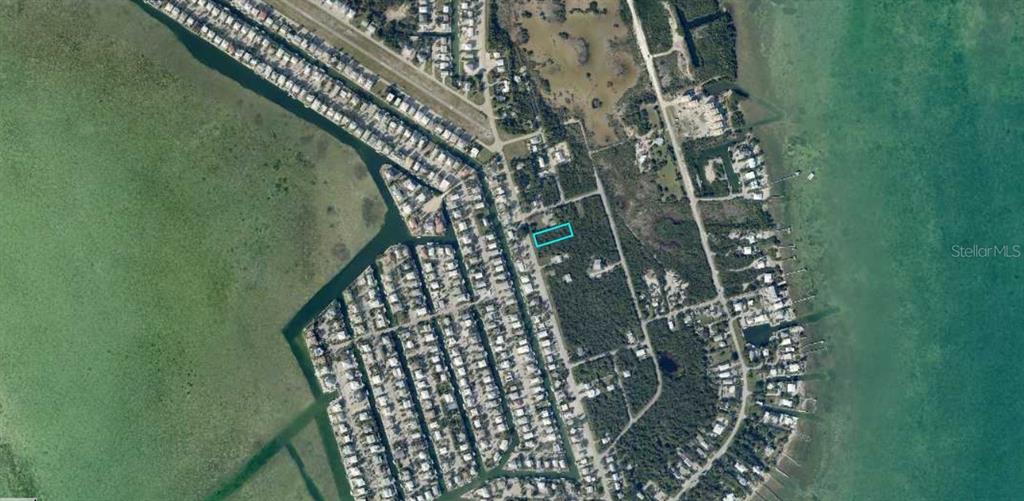 An aerial map view shows a vacant rectangular lot highlighted in blue within a neighborhood — SUNSET BOULEVARD, SUMMERLAND KEY, FL