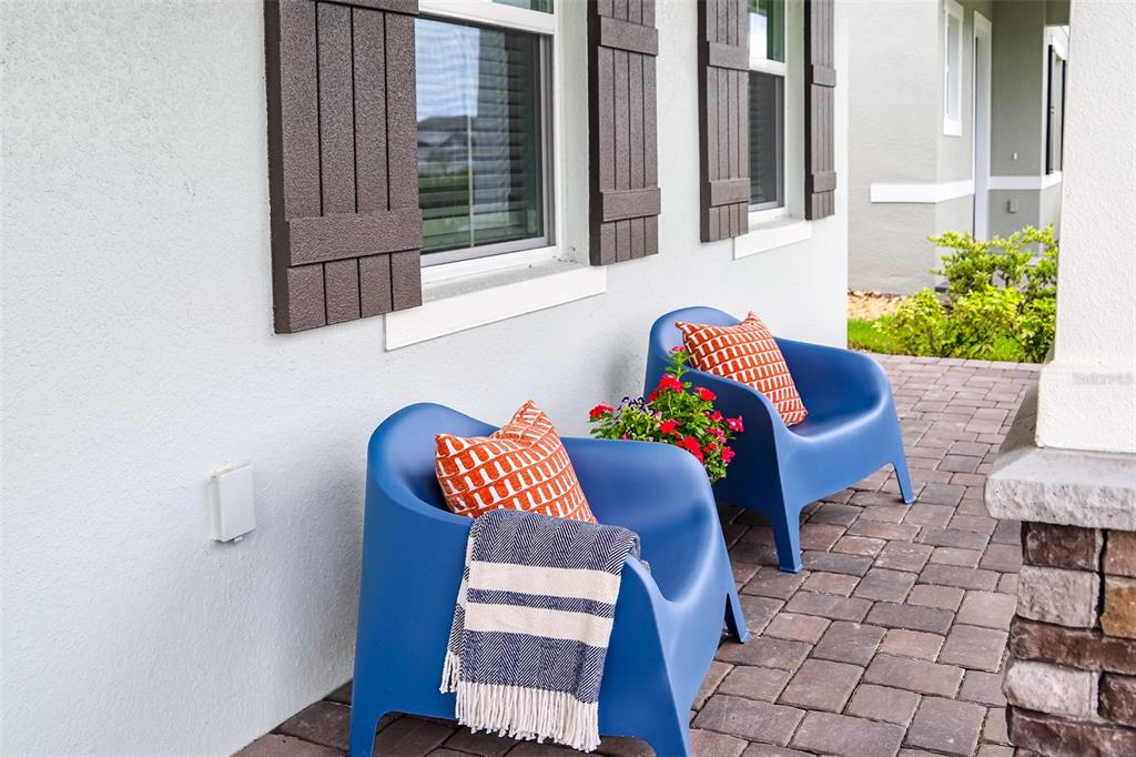 Two blue chairs with patterned pillows and a throw blanket sit on a paved patio — 798 MIDDLETON STREET, DEBARY, FL