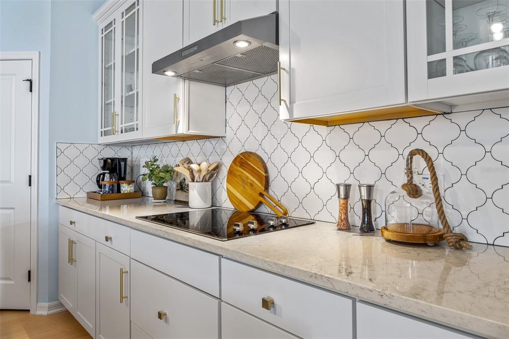 A kitchen features white cabinets, a patterned tile backsplash, and a smooth-top electric cooktop — 798 MIDDLETON STREET, DEBARY, FL
