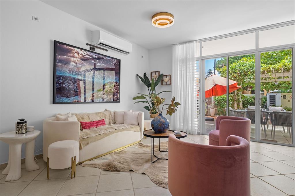 A living room features a cream sofa, two pink armchairs, and a sliding glass door — 300 HARBOUR DRIVE UNIT A7, HUMACAO, PR