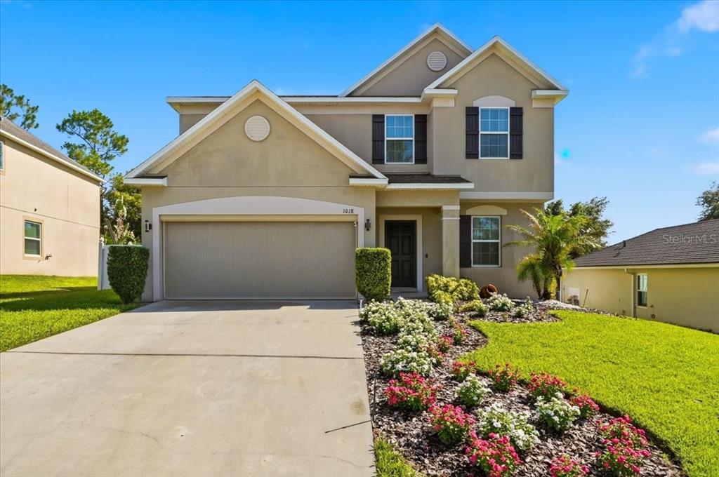 A two-story suburban house with a two-car garage and a landscaped front yard — 1018 ROBERTA ROAD, LAKE WALES, FL