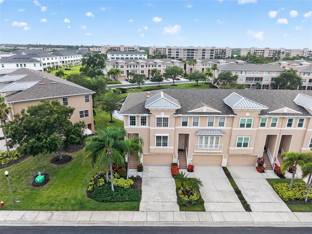 An aerial view of a multi-story townhouse complex with driveways and landscaped green spaces — 7172 ISLAMORADA CIRCLE, SEMINOLE, FL