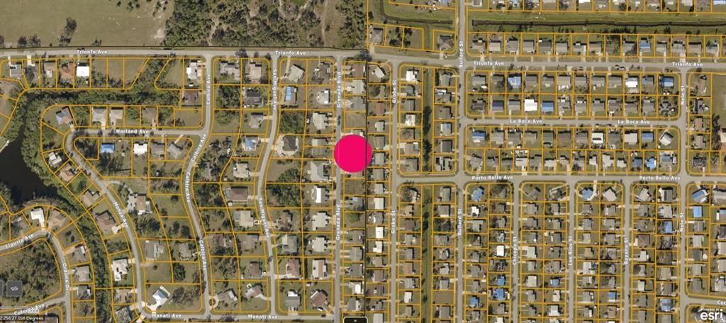 This is an aerial map showing a residential neighborhood with a pink dot marking a lot — GRANADA BOULEVARD, NORTH PORT, FL