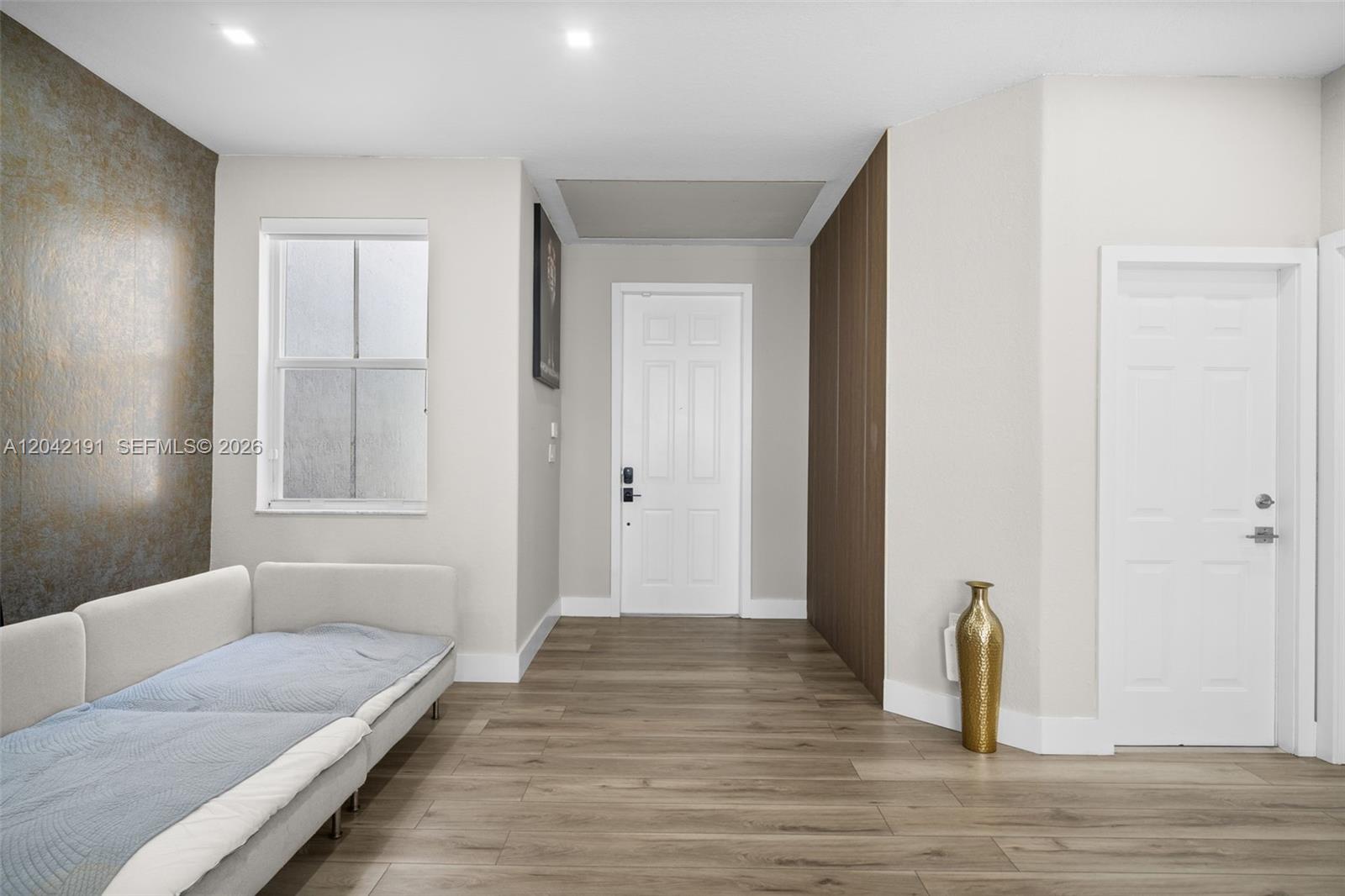 A room features light wood-look flooring, a white sofa, and two white doors — 10743 NW 78th Ter, Doral FL 33178, DORAL, FL