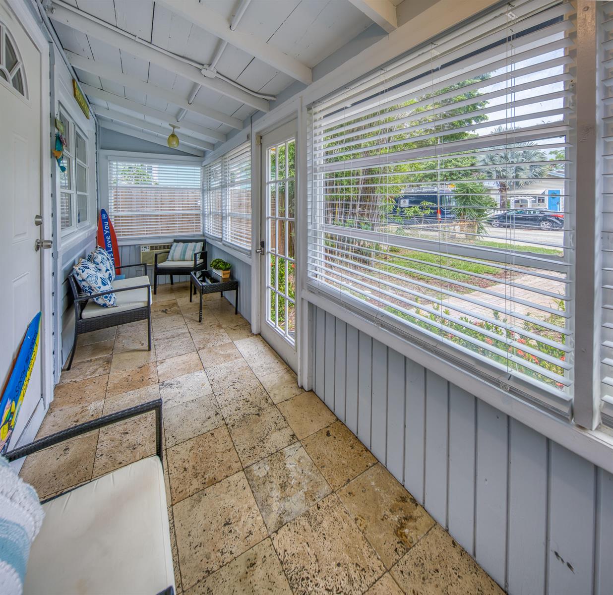 A sunroom with tile flooring, white paneled walls, and large windows with horizontal blinds — 523 N K Street, FL 33460, FL