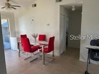 A dining area features a glass table with four red chairs on a tiled floor — 124 E 17TH STREET, ST CLOUD, FL