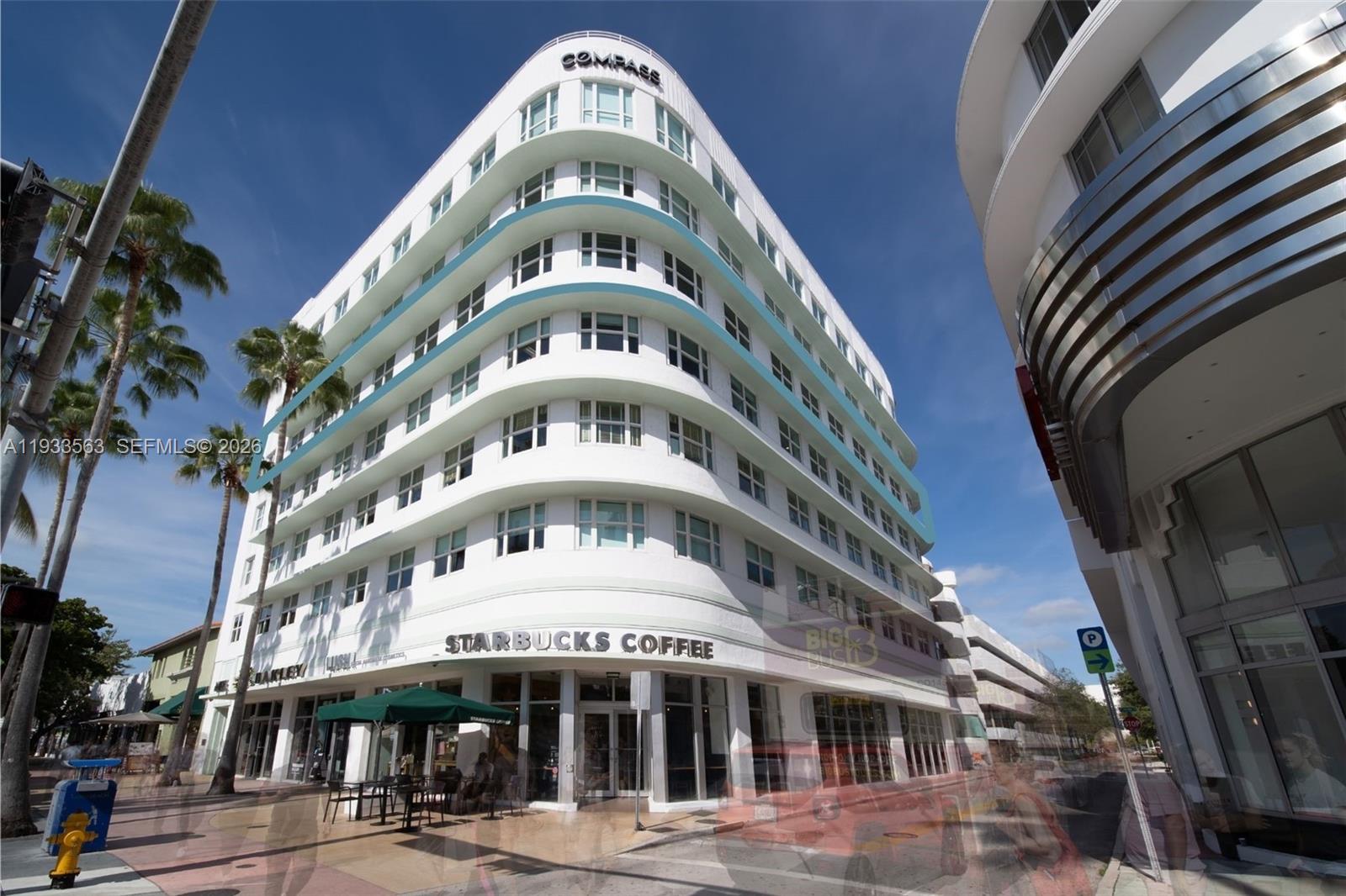 A multi-story white building with curved corners features a ground-level Starbucks and palm trees — 605 Lincoln Rd # 500, Miami Beach FL 33139, MIAMI BEACH, FL