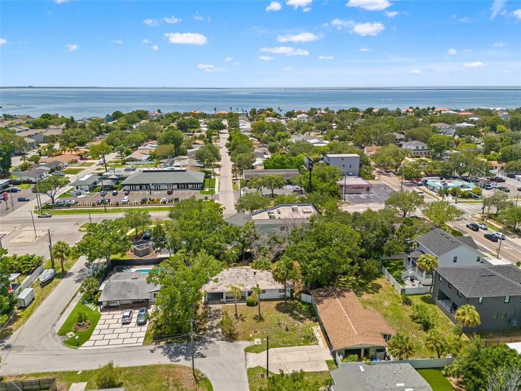 An aerial view shows a residential neighborhood near a large body of water — 4635 W BAY VILLA AVENUE, TAMPA, FL