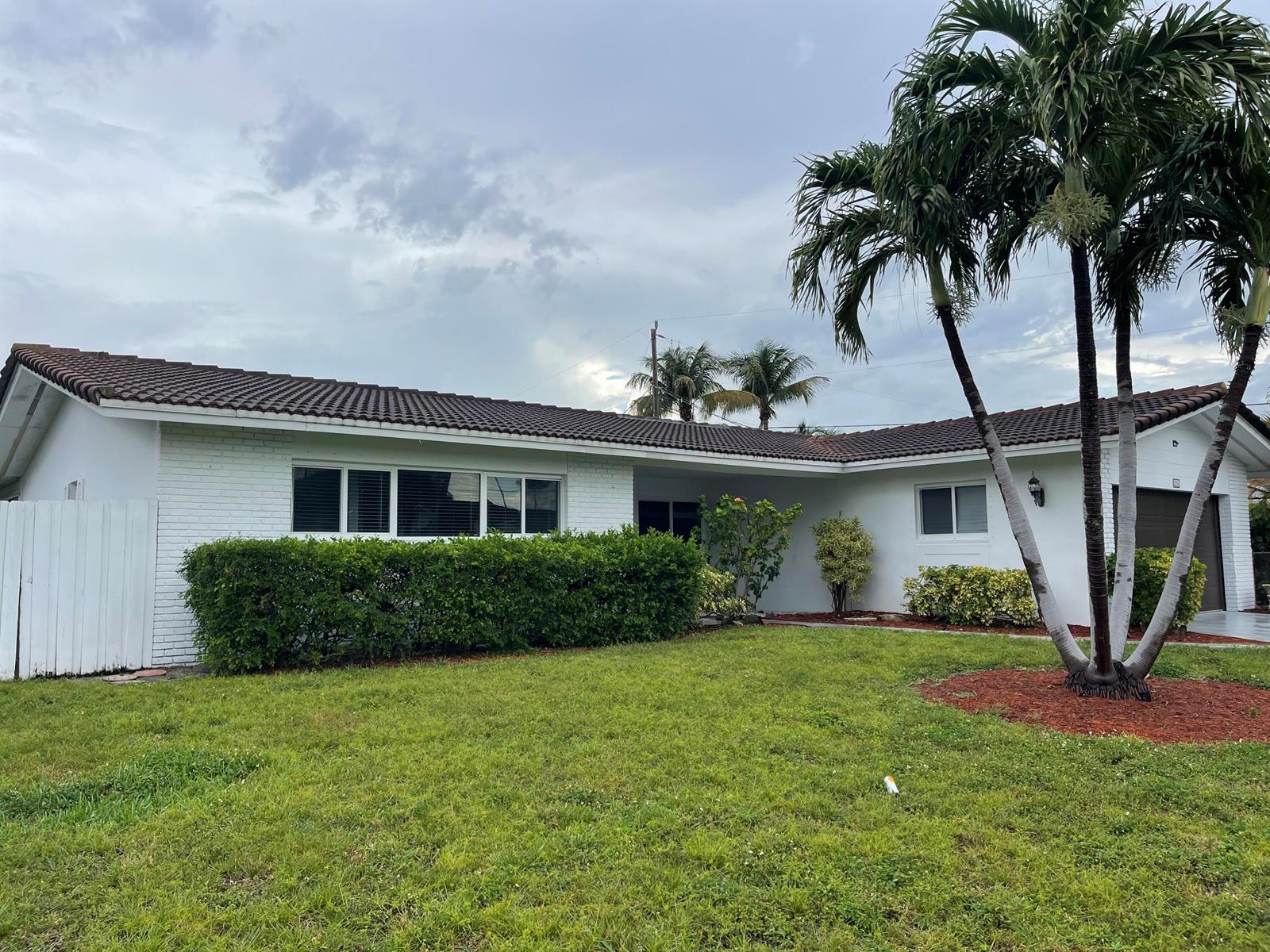 A white brick ranch-style house with a brown tile roof and a palm tree — 2910 NE 40th Court, Lighthouse Point FL 33064, LIGHTHOUSE POINT, FL