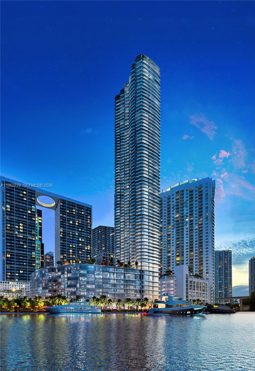 This is a digital rendering of a tall, modern skyscraper overlooking a waterfront with yachts — 99 SE 5th street, Miami FL 33131, MIAMI, FL