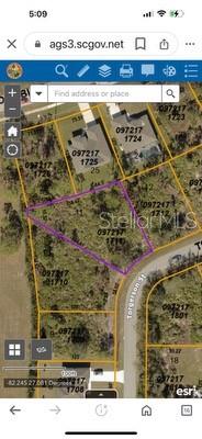 This is a satellite map view showing a highlighted parcel of land and surrounding lots — 0 TORGERSON STREET, NORTH PORT, FL
