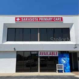 The exterior of a two-story commercial building features a Sarasota Primary Care sign and available space — 3131 CLARK ROAD UNIT 101, SARASOTA, FL