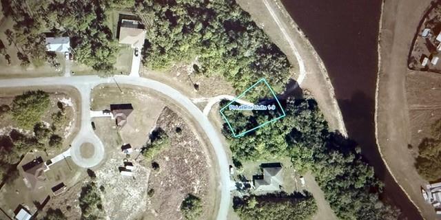An aerial map view shows a vacant, wooded residential lot outlined in blue — 3025 E Briarwood Circle, FL 33935, FL