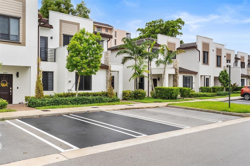 A row of modern white townhouses with parking spaces in the foreground — 340 NE 208th Terrace # 340, Miami FL 33179, MIAMI, FL