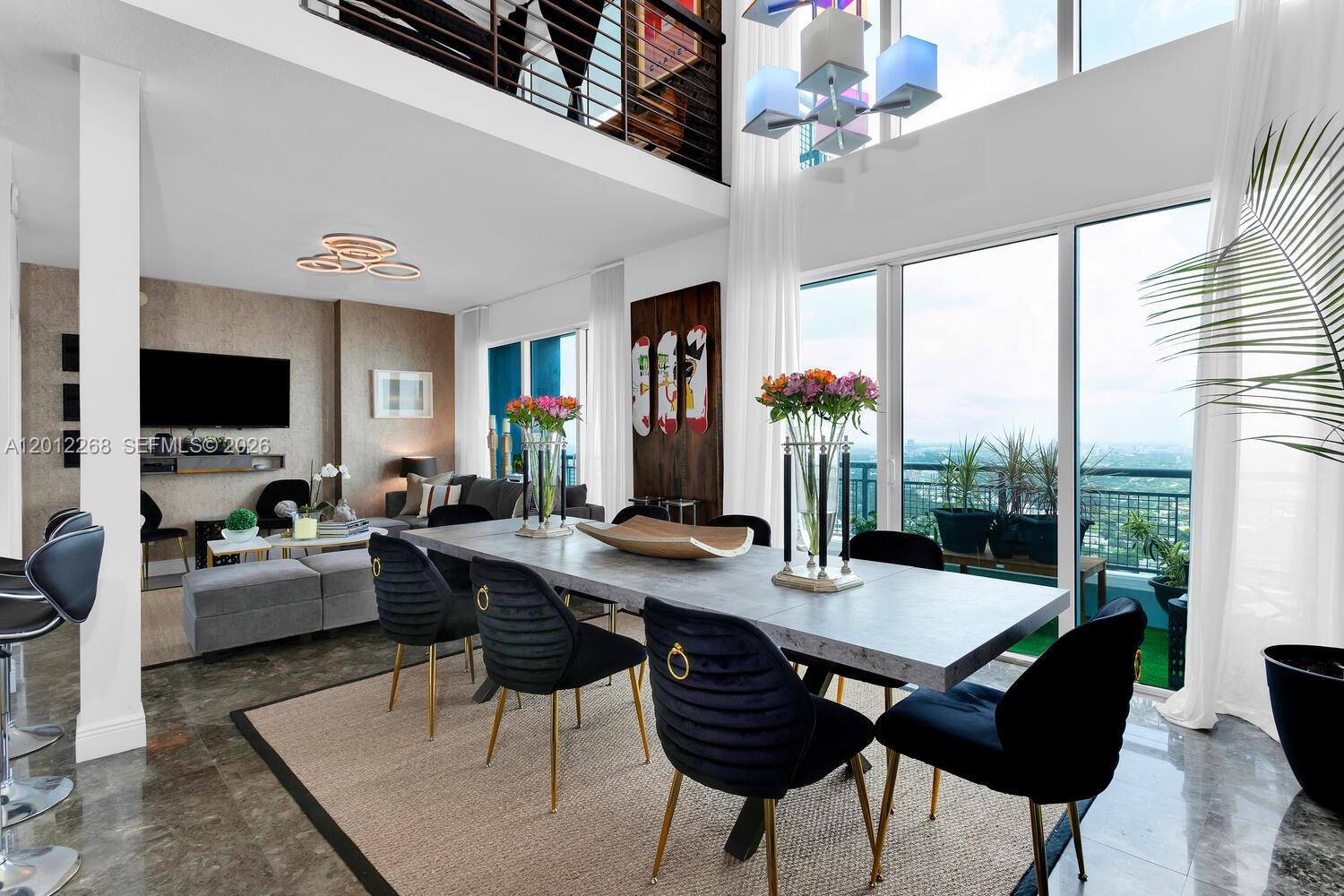 A modern dining area features a gray table, black chairs, and floor-to-ceiling windows — 60 SW 13th St # 4005, Miami FL 33130, MIAMI, FL