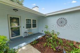 A single-story house with a light blue exterior, a concrete walkway, and a landscaped front yard — 1901 N LAKE ELOISE DRIVE, WINTER HAVEN, FL