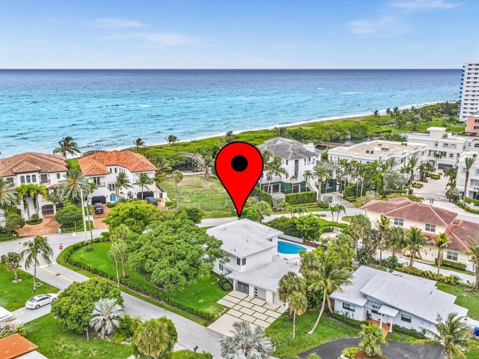 An aerial view shows a coastal home with a pool, lush landscaping, and ocean views — 1903 Bay Drive, Pompano Beach FL 33062, POMPANO BEACH, FL