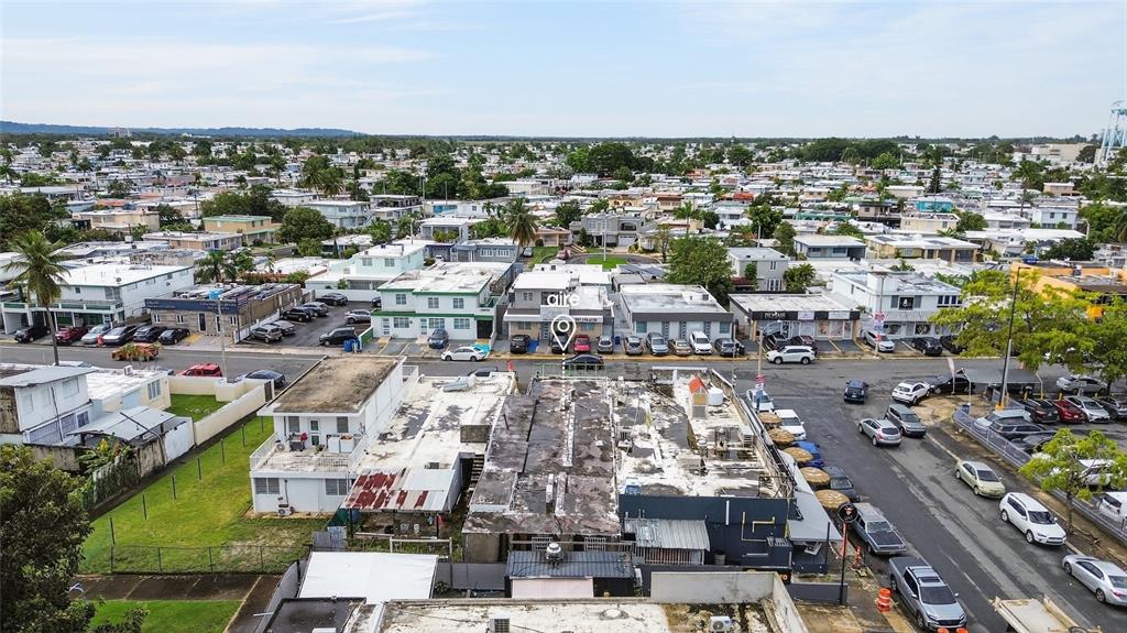 An aerial view shows a commercial building with a flat roof in a residential neighborhood — Local 1, Urb. La Rosaleda AVE. BOULEVARD MONROIG, TOA BAJA, PR