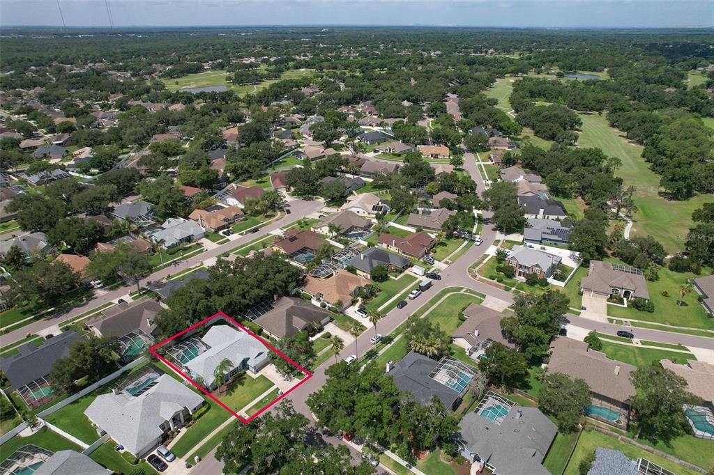 An aerial view shows a single-story house with a screened pool enclosure outlined in red — 2327 EAGLE BLUFF DRIVE, VALRICO, FL