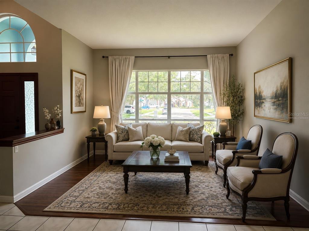A living room features a sofa, two armchairs, a coffee table, and a large window — 2327 EAGLE BLUFF DRIVE, VALRICO, FL