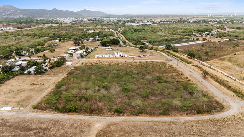 An aerial view shows a large, rectangular, undeveloped plot of land surrounded by rural roads — OBDULIA, SANTA ISABEL, PR