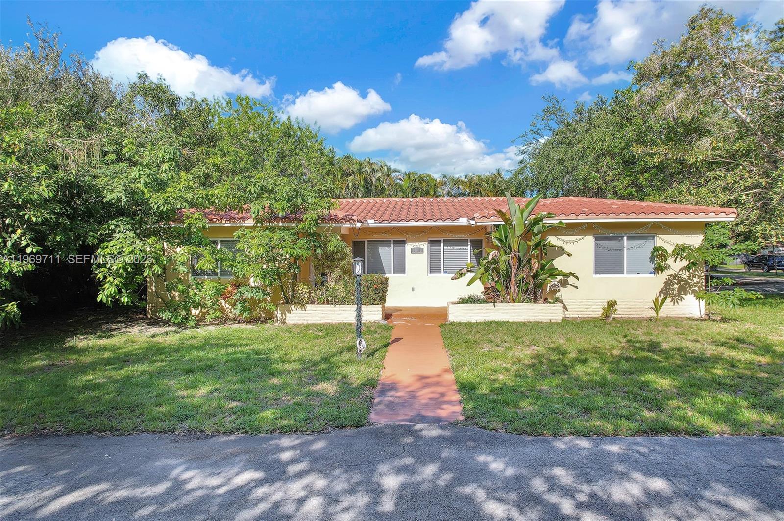 A single-story house with a red tile roof and a front walkway sits on grass — 11919 NE 8th av, Biscayne Park FL 33161, BISCAYNE PARK, FL