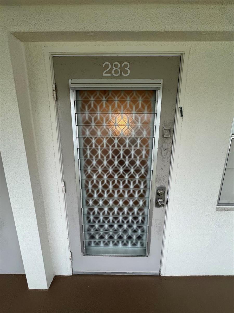 A gray exterior door with a patterned glass insert and the number 283 above it — 283 Ventnor # 283, Deerfield Beach FL 33442, DEERFIELD BEACH, FL