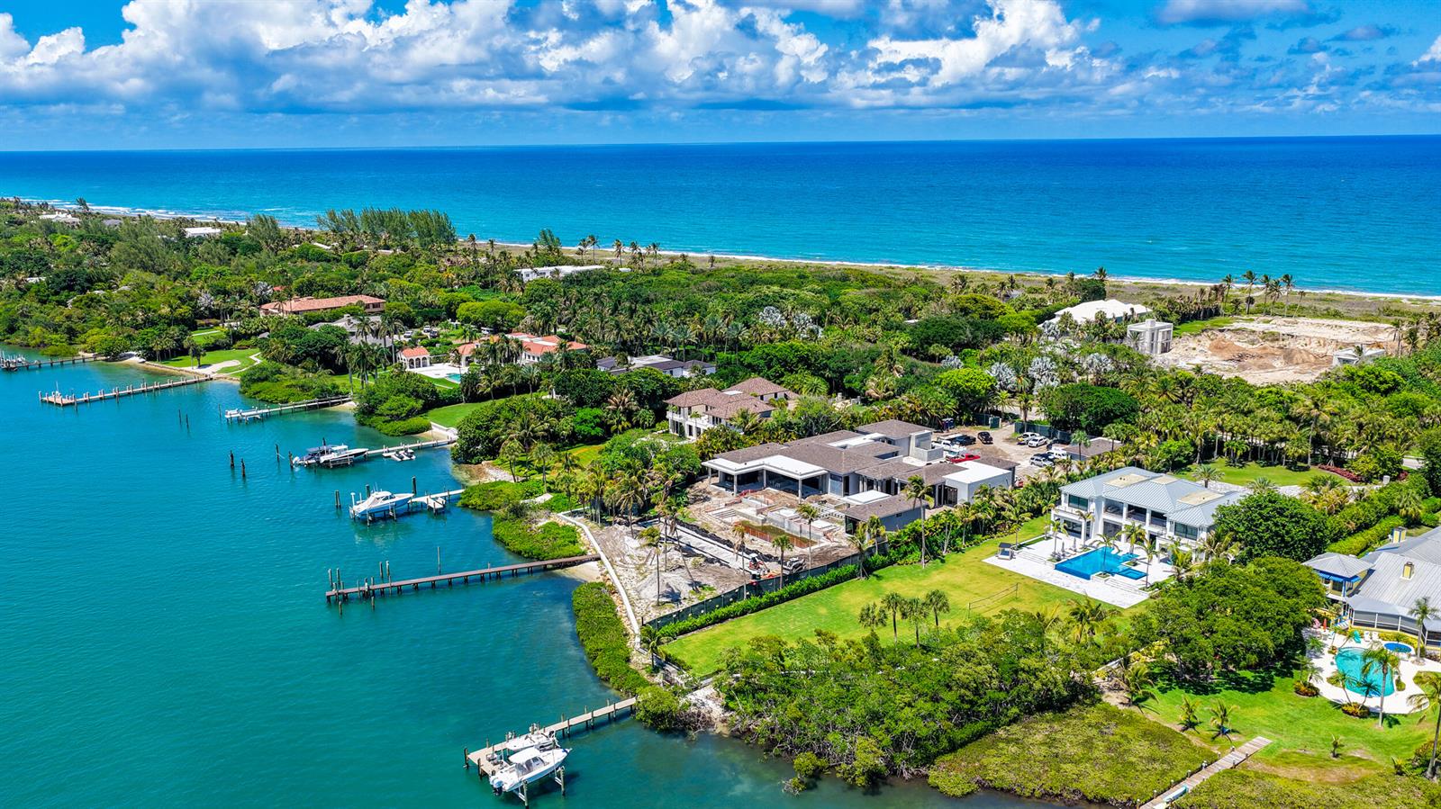 An aerial view shows waterfront luxury homes with private docks and pools along the coast — 508 S Beach Road, Jupiter Island FL 33455, JUPITER ISLAND, FL