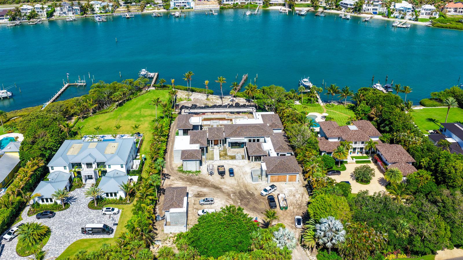 An aerial view shows a large waterfront estate under construction with surrounding homes and docks — 508 S Beach Road, Jupiter Island FL 33455, JUPITER ISLAND, FL